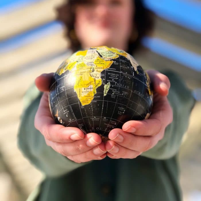 someone holding a globe