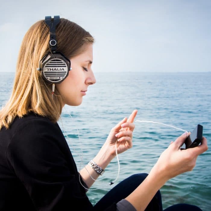 woman listening to music at the lake