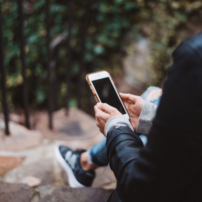 Woman Looking at Blank Phone