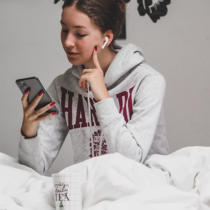 Girl Holding Phone With Earphones