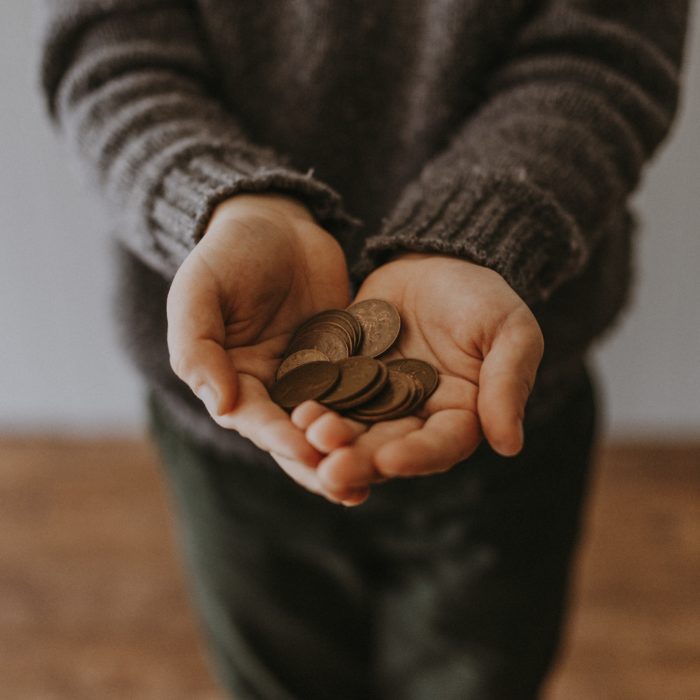 Person Handing Out Coins