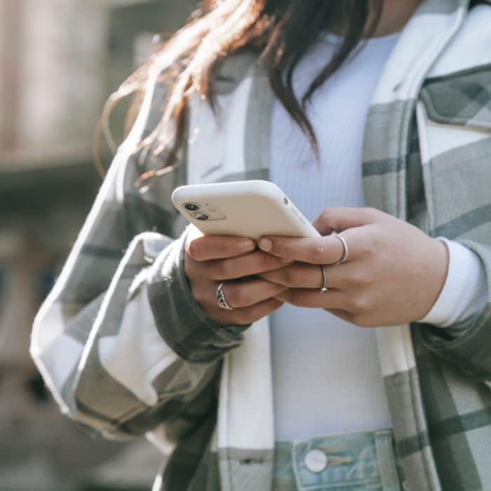 Woman in Checkered Clothes Holding Phone