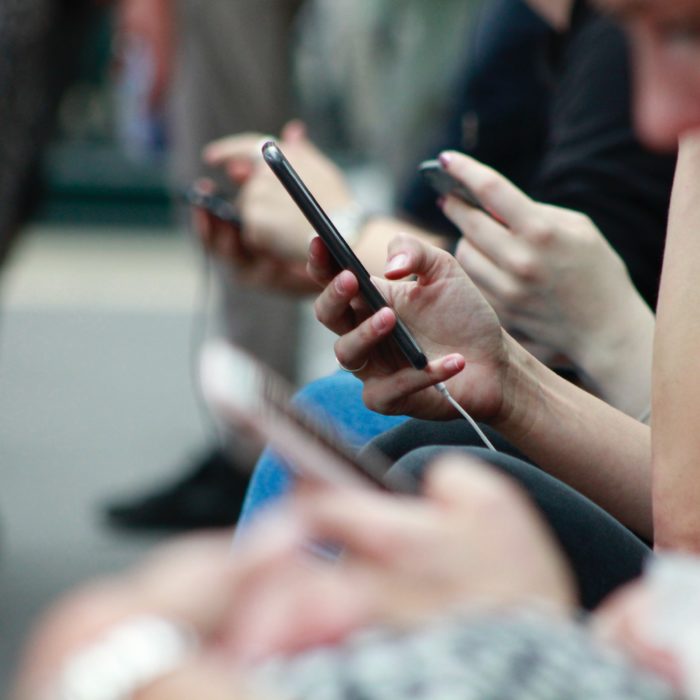 Multiple People Holding Phones