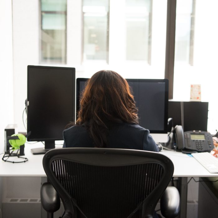 Girl Sitting In Front of a Computer