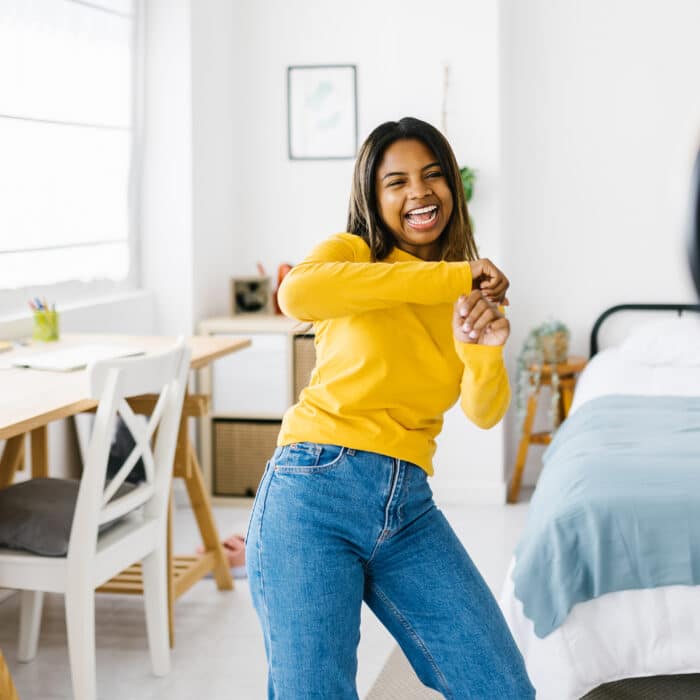 Hispanic latina young creator woman recording herself while dancing