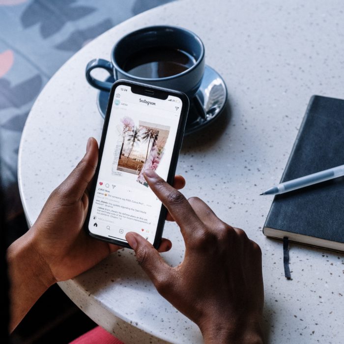 Person Having Coffee While Using Phone