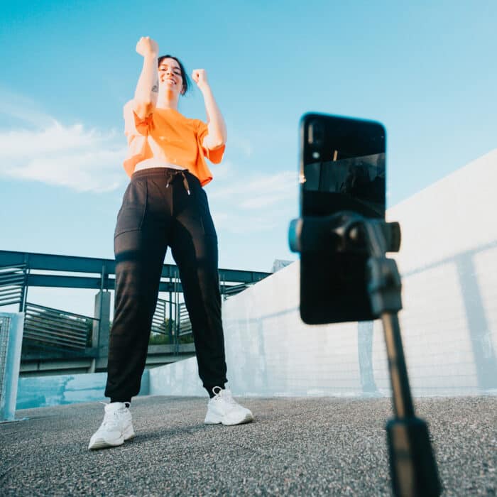Young woman recording herself dancing