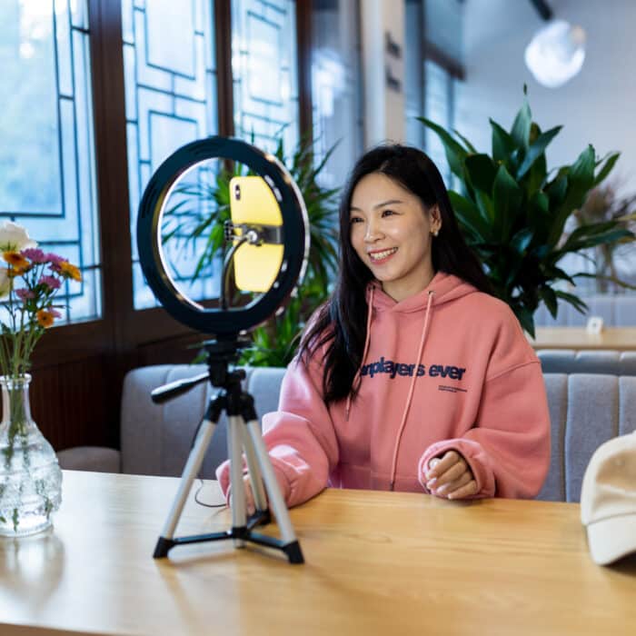 young woman using phone and ring light