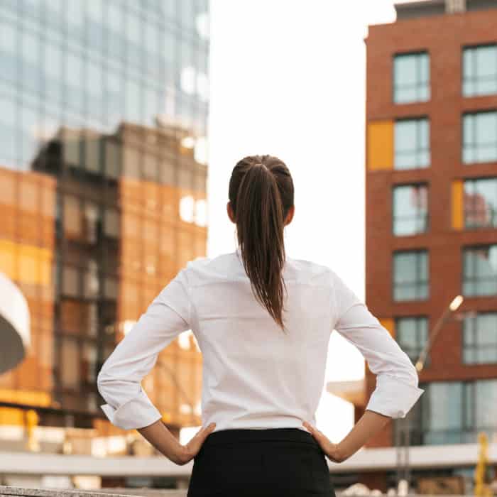 Rear view of businesswoman looking business buildings