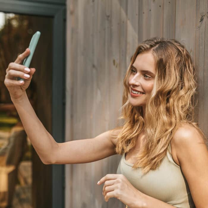 Beautiful woman taking selfie on smartphone