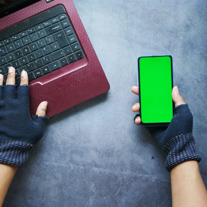 Hacker hand stealing data from smart phone