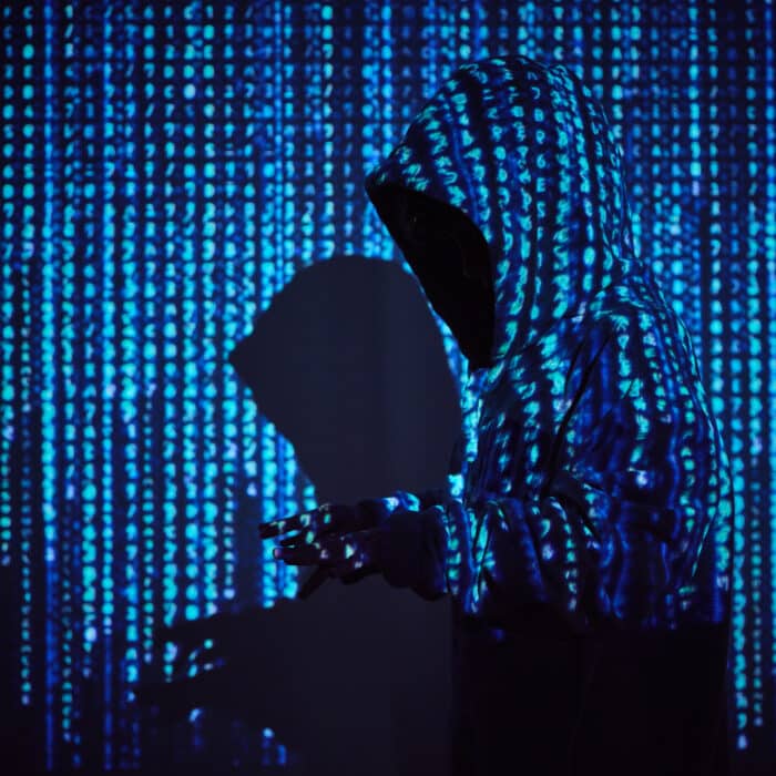 Hacker in binary code projection