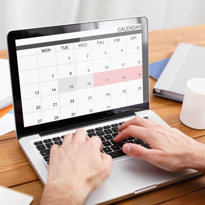 Man Working With Calender Planner On Laptop In Office, Managing Business Schedule