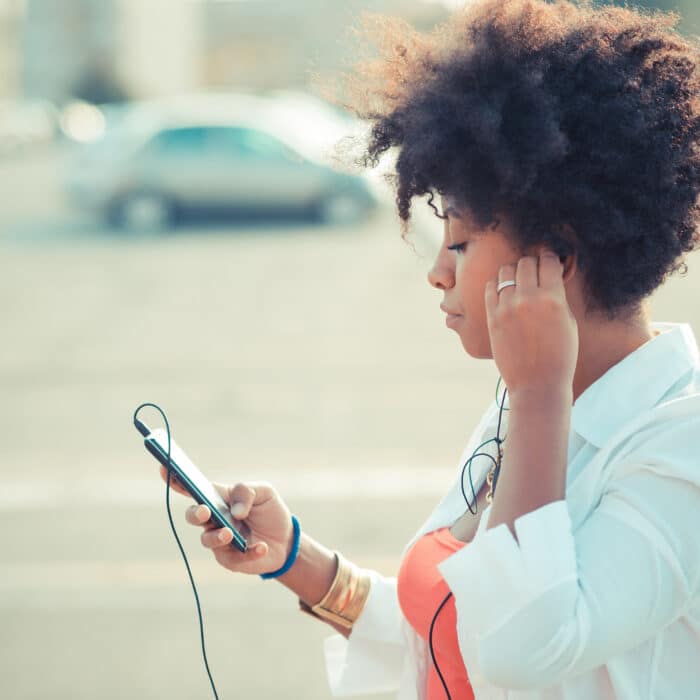 Young woman listening to smartphone music